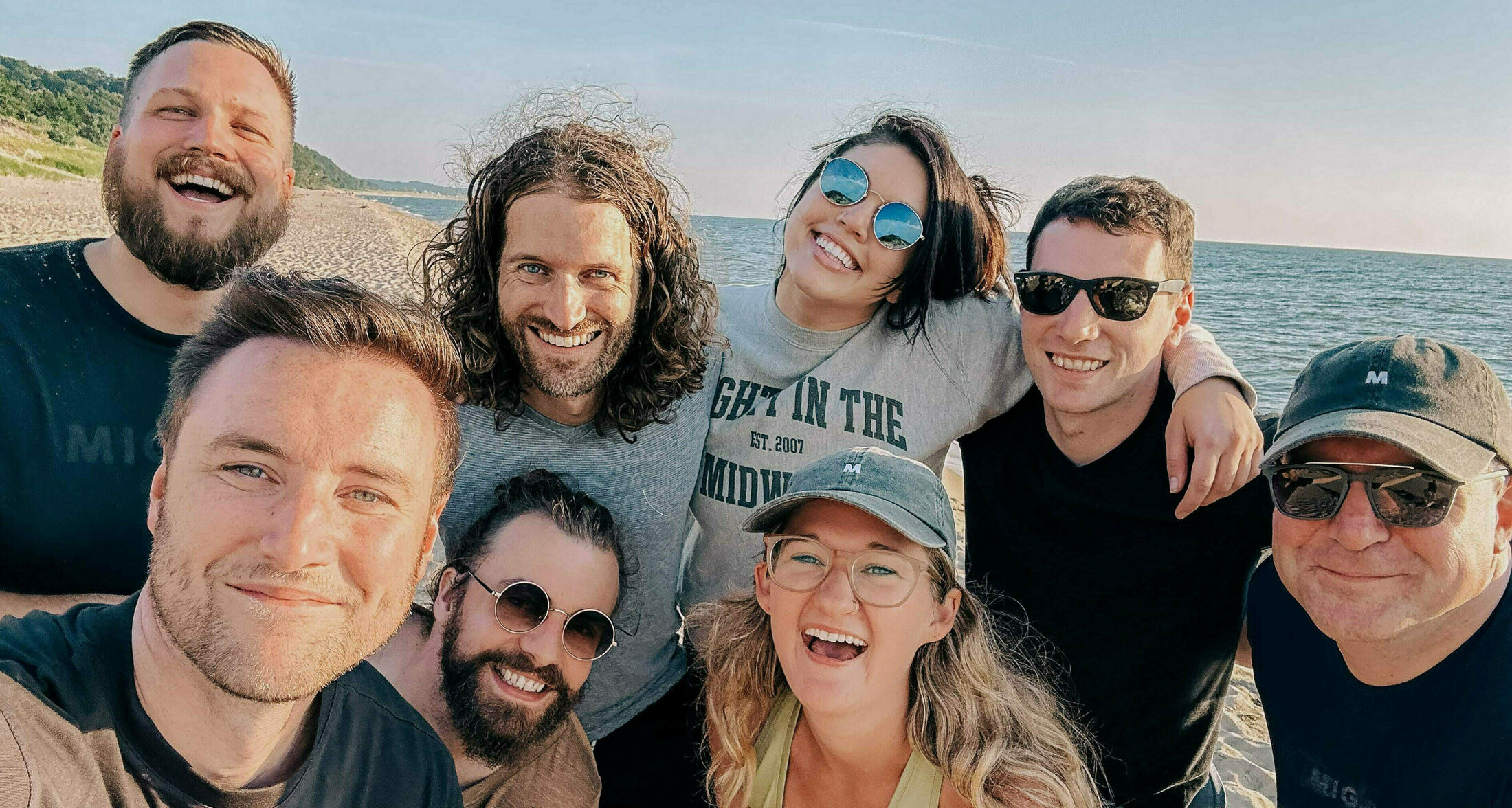 Mighty team members smiling on the beach