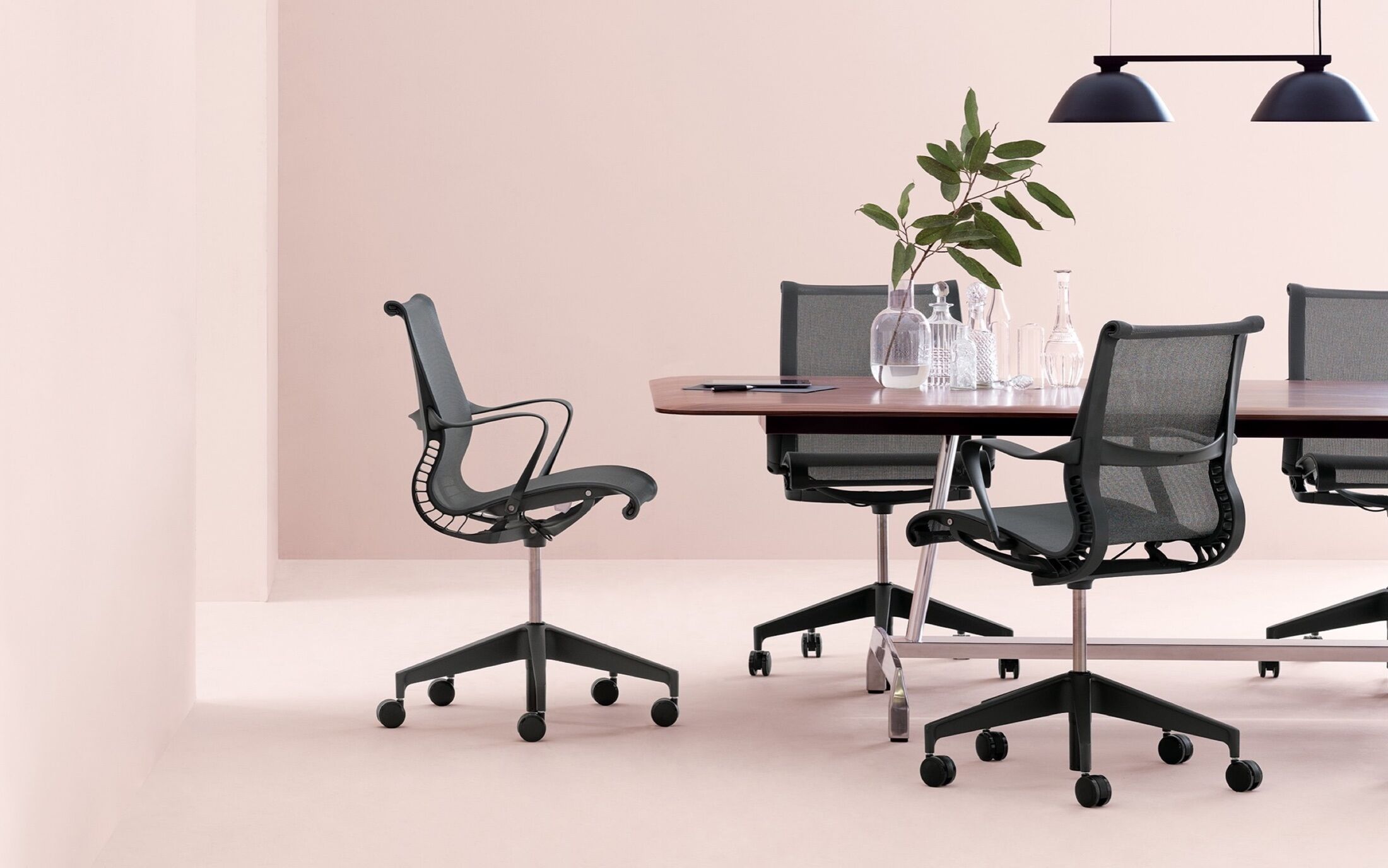 Conference Room with Herman Miller table and chairs on pink background